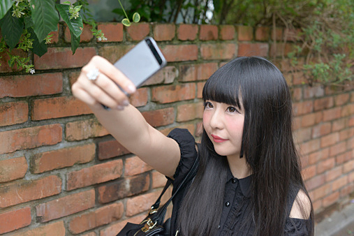 Harajuku woman taking self portrait with smartphon